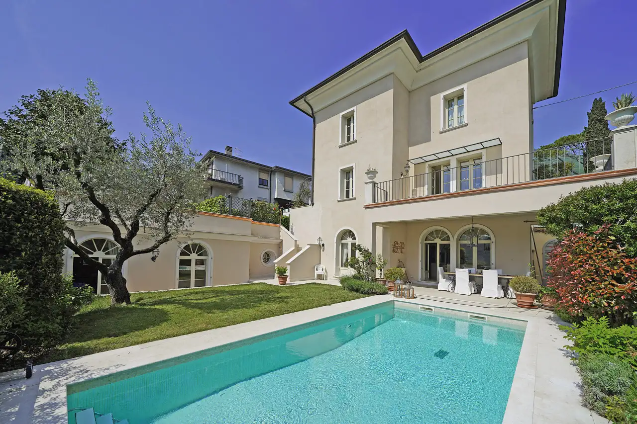 Rectangular pool with garden and villa in the background