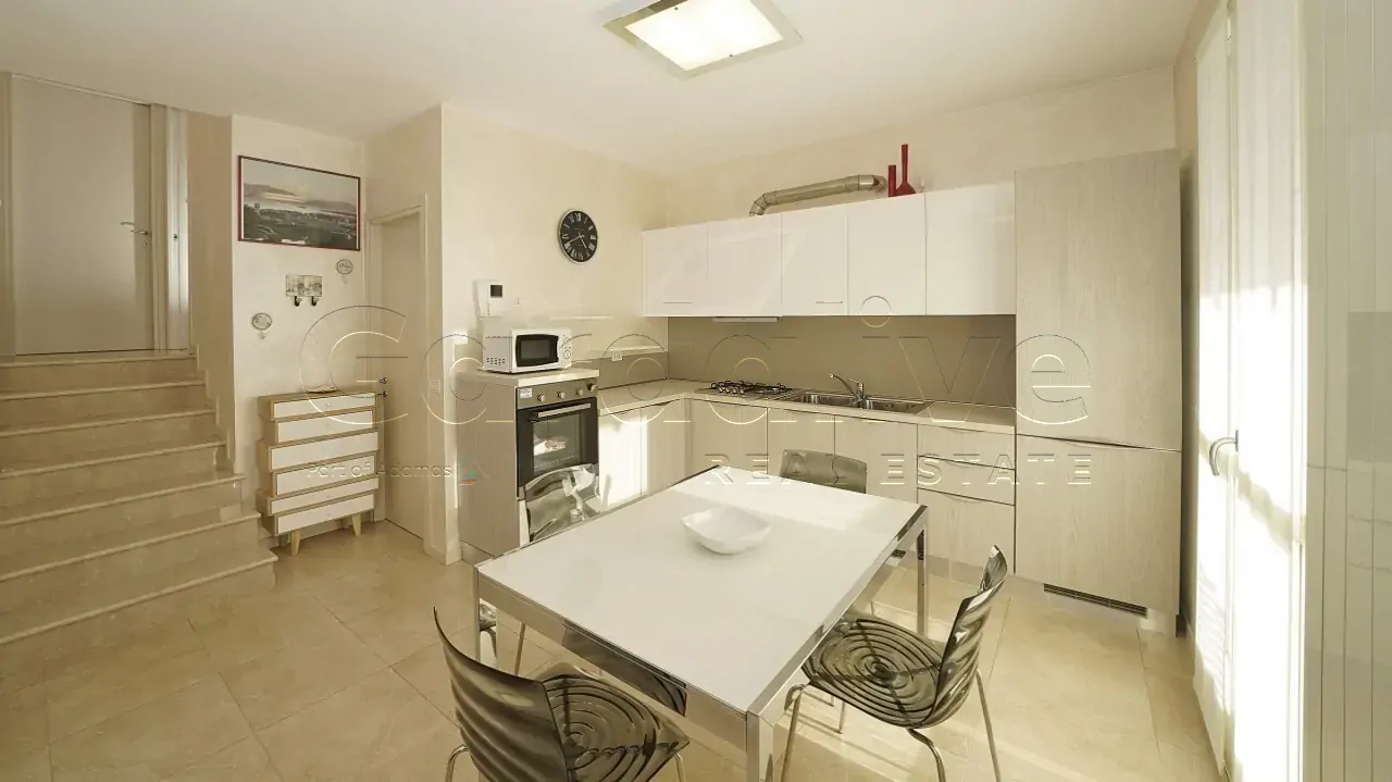 Kitchen with table and chairs near internal stairs