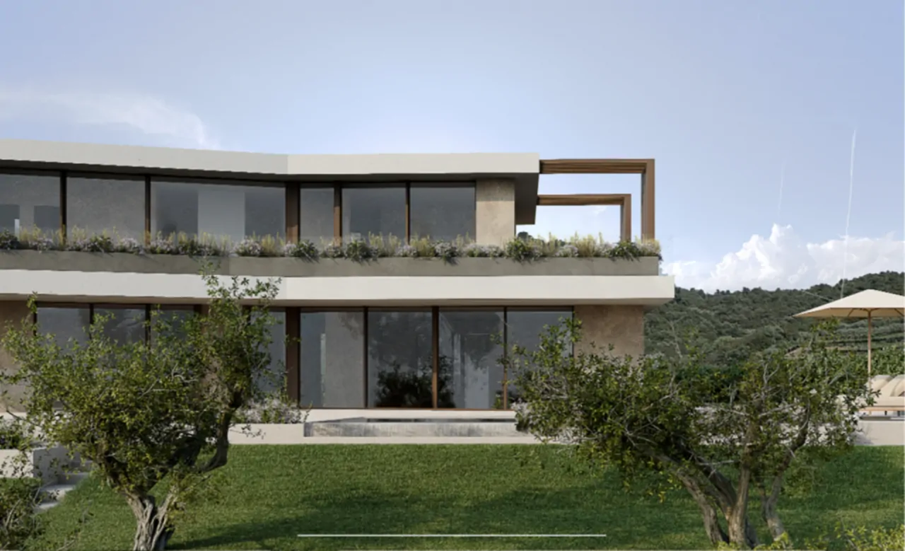 Facciata moderna della villa con ampie vetrate e giardino