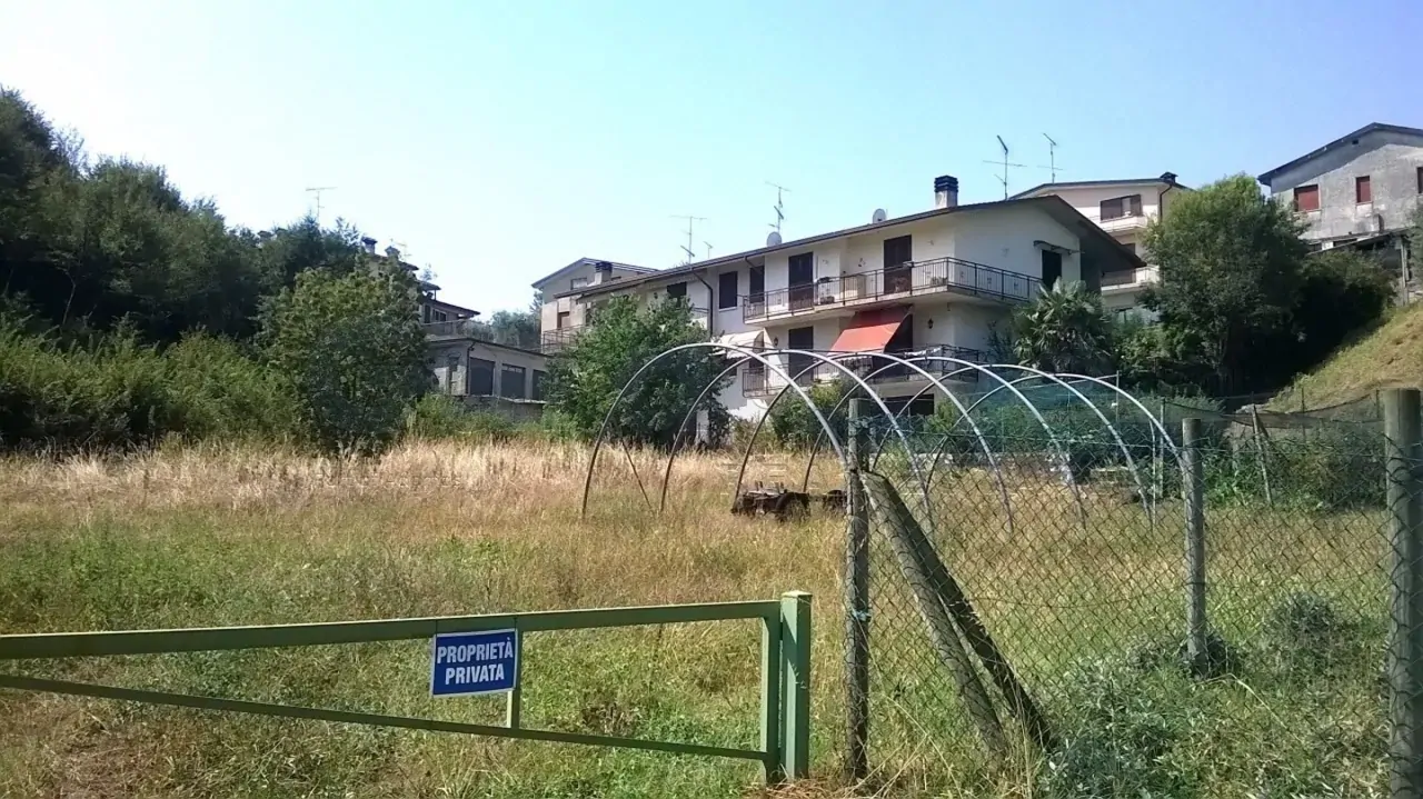 Fenced land with grass and metal structures
