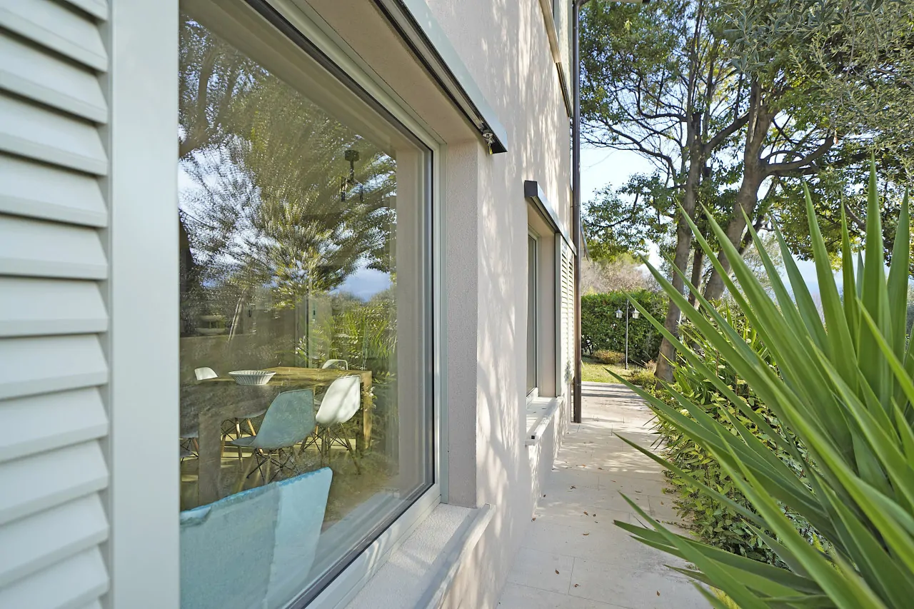 House facade with window and side vegetation