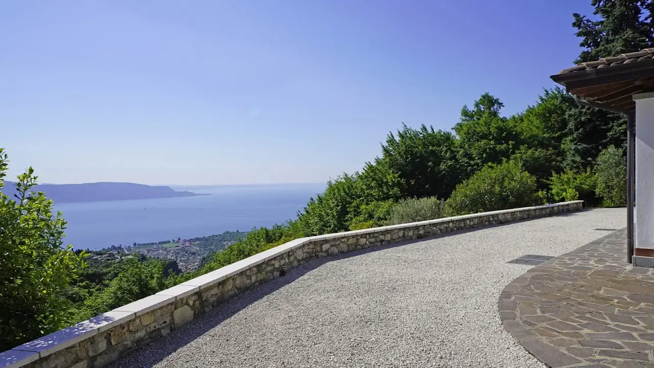 Exterior with view of Lake Garda and gravel driveway