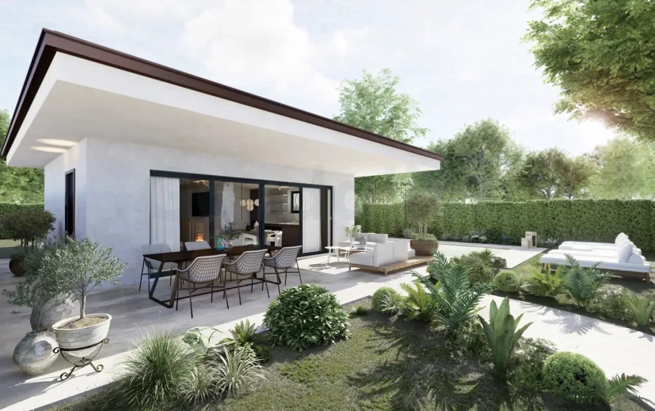 Exterior of modern villa with garden and outdoor dining area