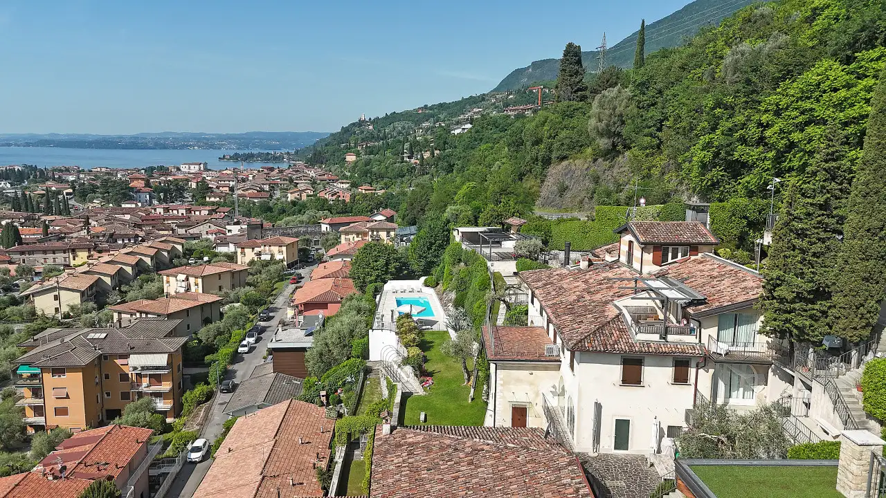 Aerial view of the town with pool and green hills