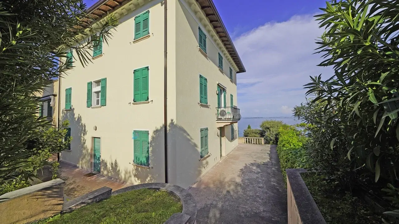Exterior of the house with green shutters and partial lake view