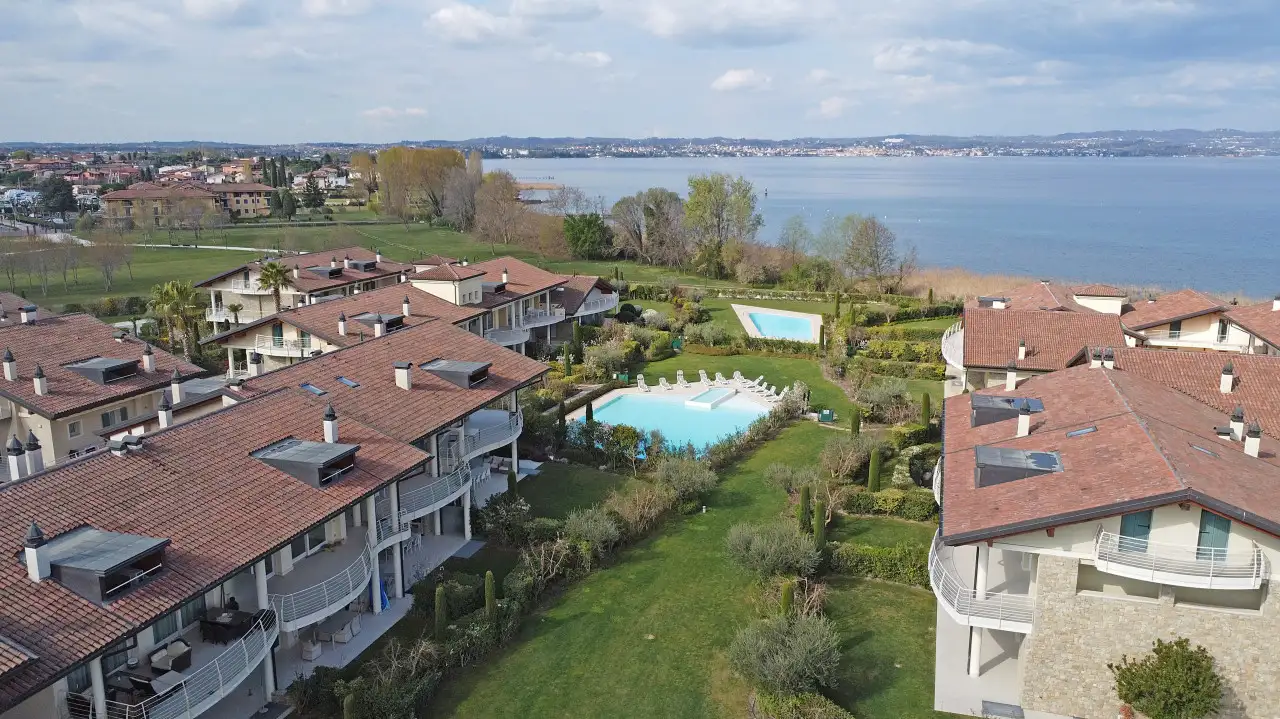 Aerial view of residential complex with pool and lake view in Sirmione