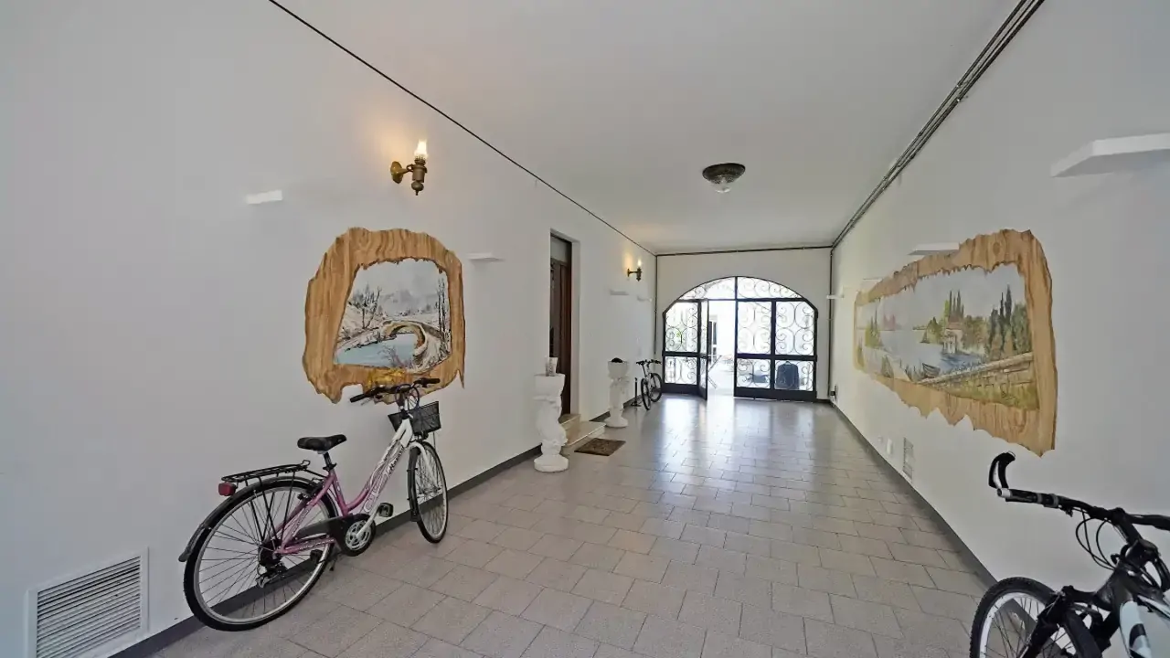 Corridor with bicycles and wall decorations