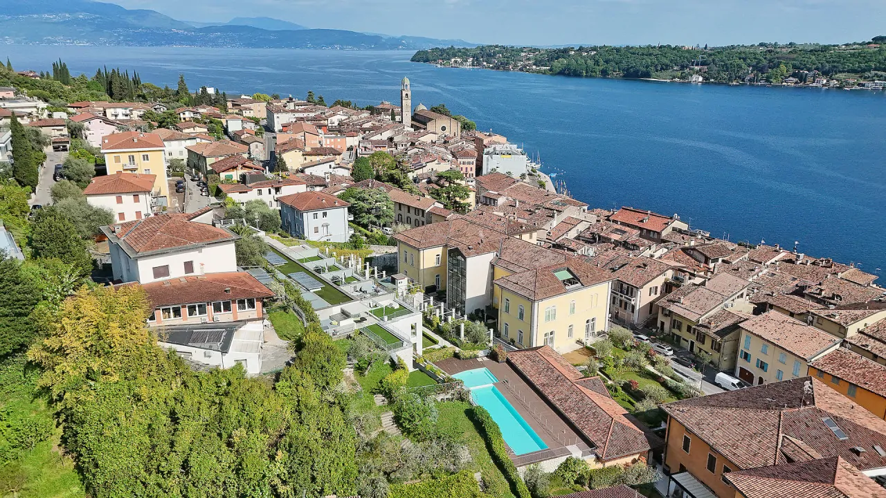 Luftaufnahme des Stadtzentrums von Salò mit See und Hügeln im Hintergrund