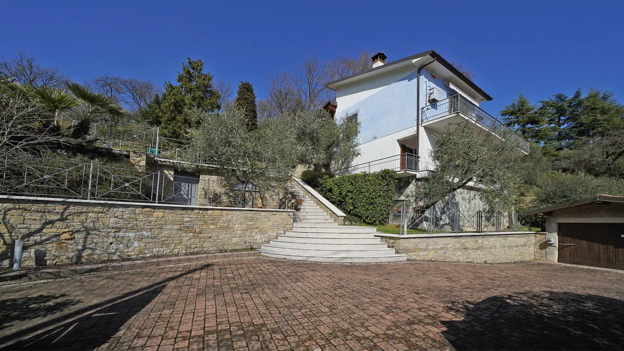 Detached villa with external stairs and stone wall