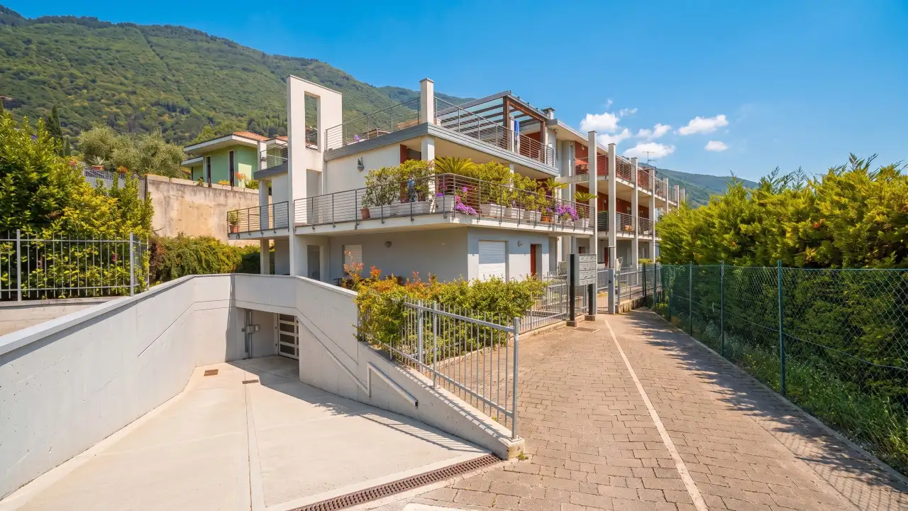Underground garage entrance with driveway and residential building