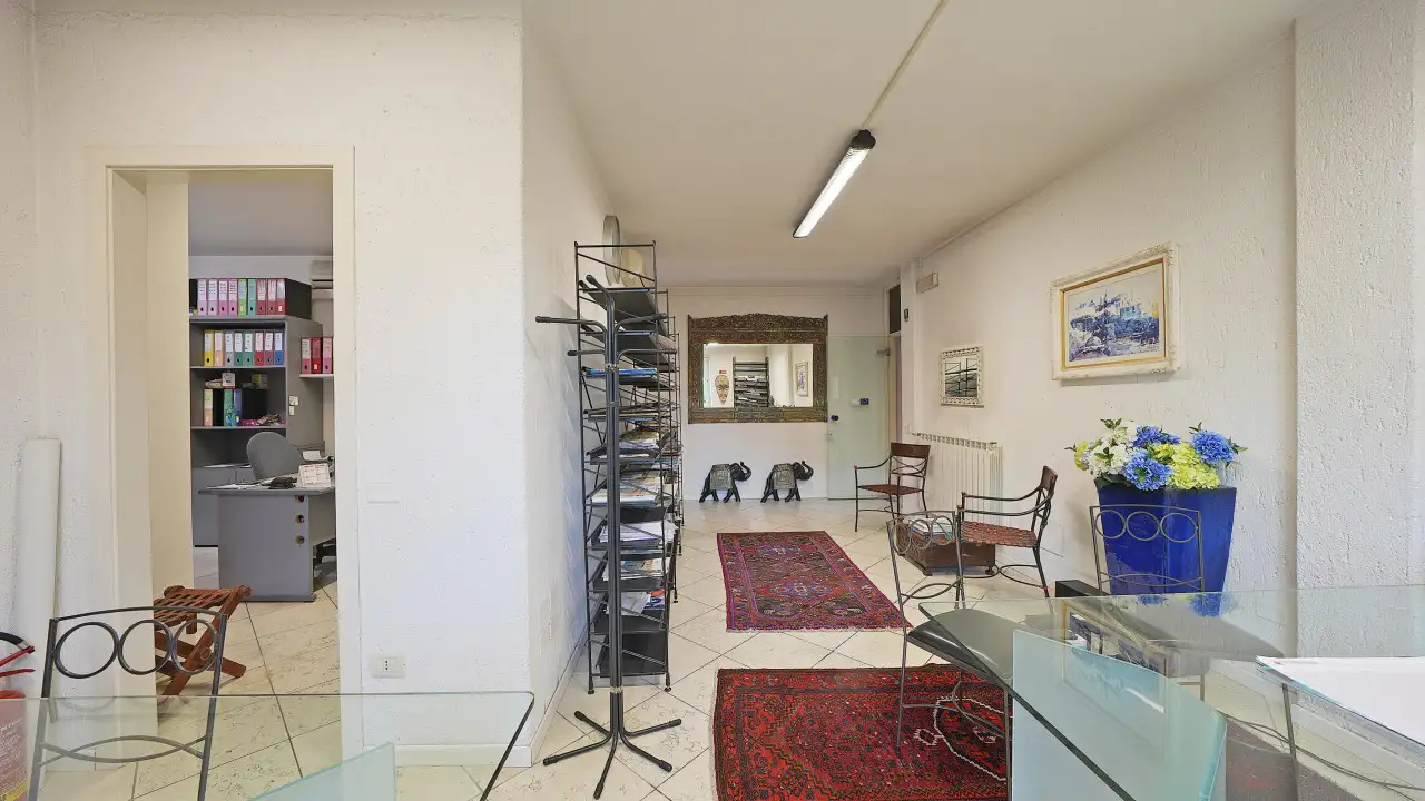 Office with glass desks and metal shelves