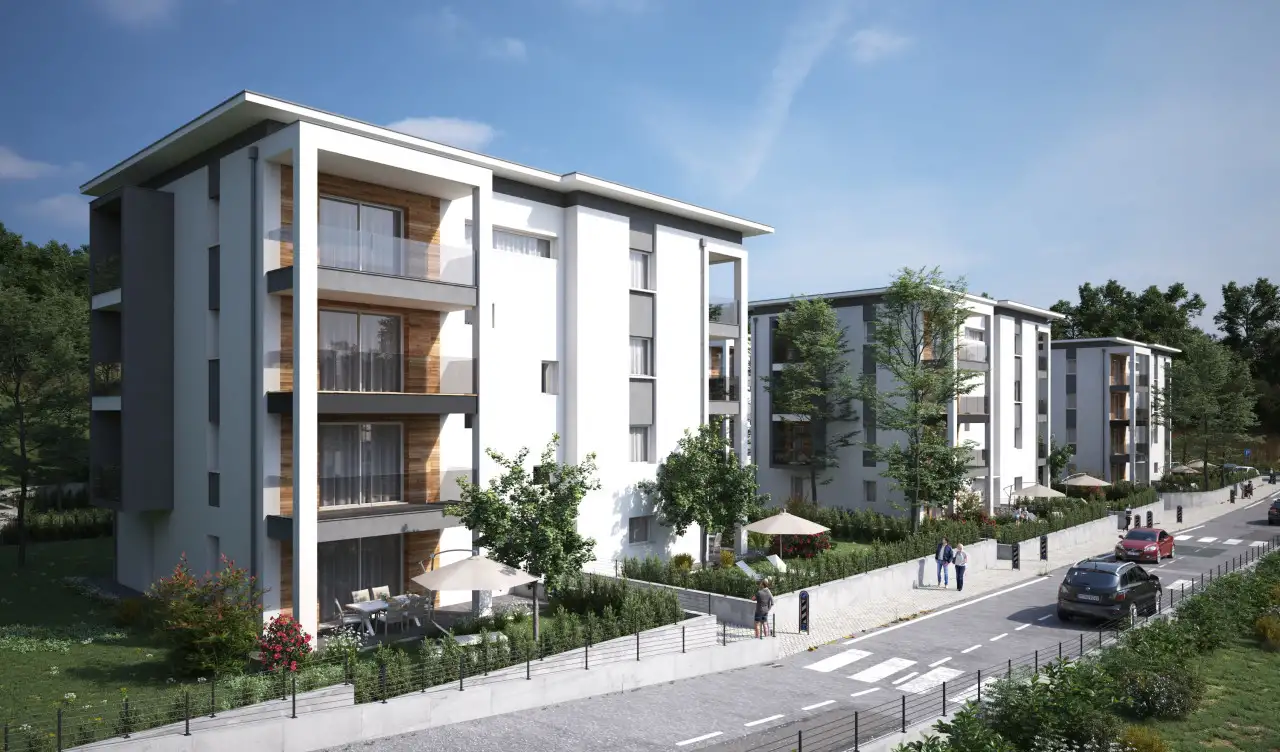 Exterior view of modern apartment buildings with gardens and sidewalk
