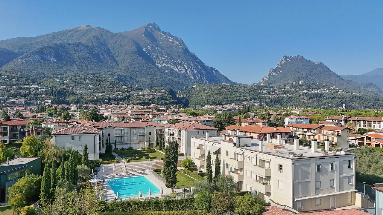 Aerial view of the residence with pool and mountains in the background in Toscolano Maderno